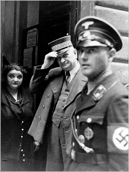 An SS officer in Vienna standing at the entrance to the Jewish community building